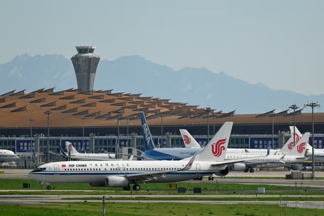 An Air China Boeing 737-800 (front) plane waits to take off at Beijing International airport on 6 July 2025(Getty Images)